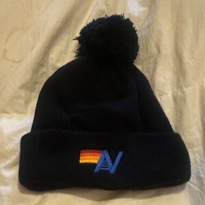 Aviator Nation
Rib Beanie in black with a rainbow logo.